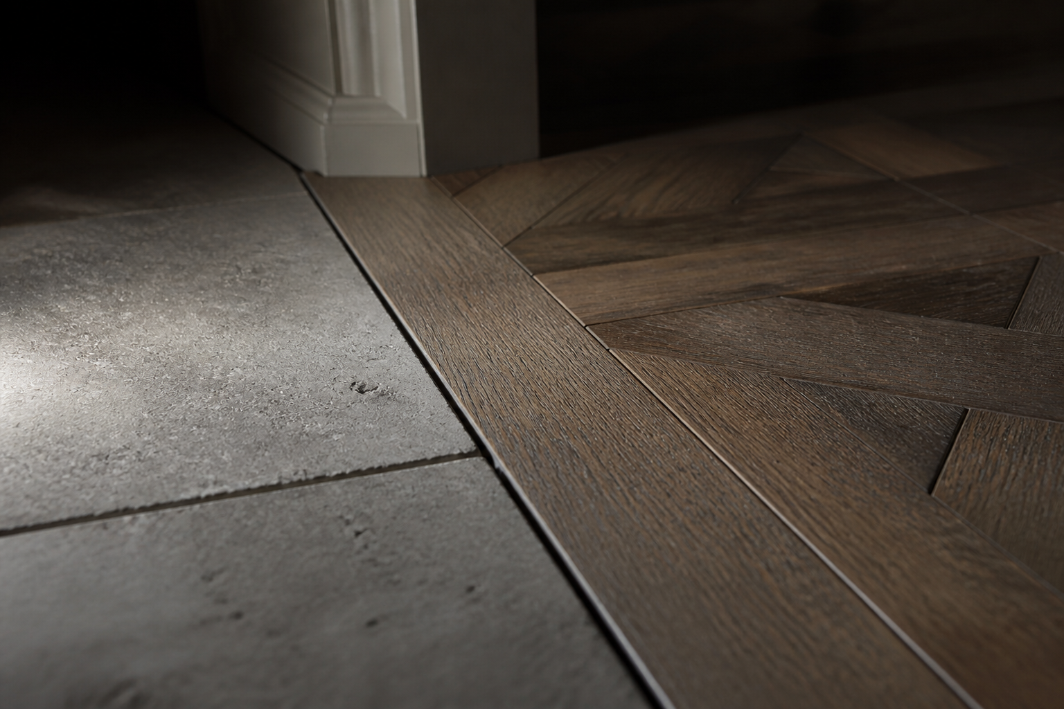 Macro detail of a perfectly aligned seam between parquet flooring and stone tiles